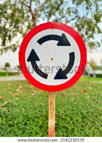 roundabout arrow sign on the road