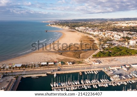 Aerial photo of Vilanova i la Geltru with view of quay and beach on shore of Mediterranean Sea.