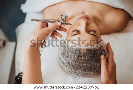 Professional cosmetologist's hands doing gas-liquid peeling procedure of the client's face. Facial treatment. Beauty treatment. Beauty skin female face Royalty-Free Stock Photo #2142239961