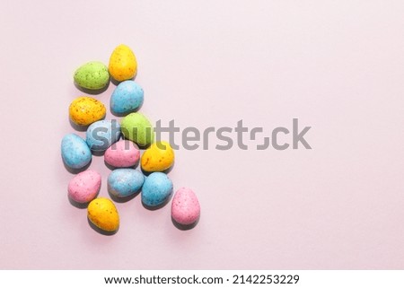 Multi-colored Easter decorative eggs on a pastel background.