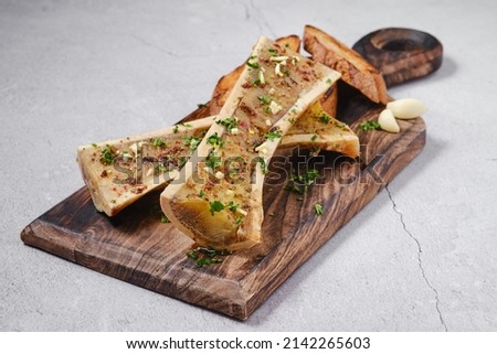 Homemade roasted beef bone marrow with garlic bread Royalty-Free Stock Photo #2142265603