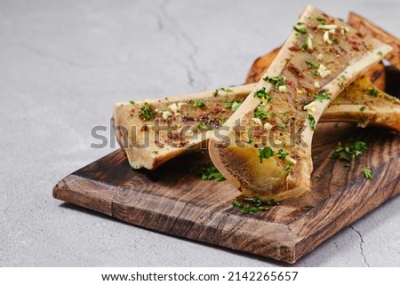 Homemade roasted beef bone marrow with garlic bread, closeup Royalty-Free Stock Photo #2142265657