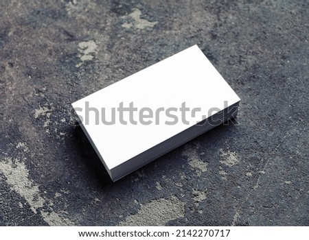 Blank white business card on concrete background. Mockup for ID. Template for graphic designers portfolios.