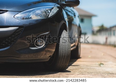 Close up bald front wheel tire. Car maintenance and service concept. Royalty-Free Stock Photo #2142283485