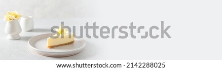 Vanilla cheesecake banner. Cheesecake New York with vanilla flower on a white background - healthy organic summer dessert pie cheesecake. Copy space for text. Confectionery web line, promotion Royalty-Free Stock Photo #2142288025
