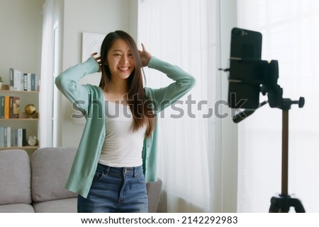 Asian young woman er created her dancing video by smartphone camera To share video to social media application Royalty-Free Stock Photo #2142292983