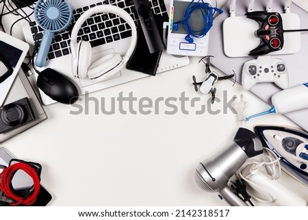 Old computers, digital tablets, mobile phones, many used electronic gadgets devices, broken household and appliances. Top view. Planned obsolescence, electronic waste for recycling concept Royalty-Free Stock Photo #2142318517