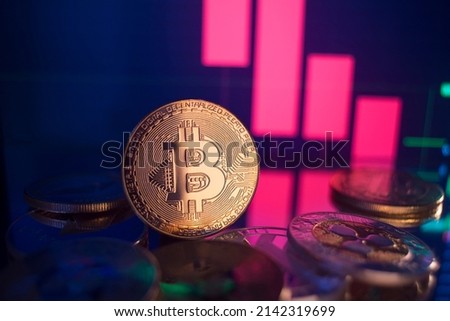 Golden coins with bitcoin logo drop at bear market. Pullback of leader cryptocurrency Bitcoin BTC in trading. Decentralized digital currency fell. Crypto collapse. Electronic money on black background Royalty-Free Stock Photo #2142319699
