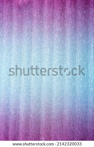 Rough texture of folded shiny metallic crepe paper or foil colored in pink to blue intense neon gradient. Abstract bright background with large copy space. Vertical orientation. View from above.