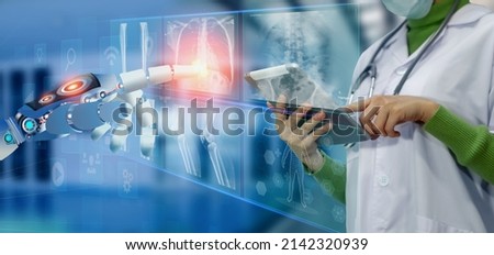 Medicine doctor and robot hand touching on a patients x-ray scans digital healthcare and connection with modern virtual screen interface icons, Medical technology and network concept.