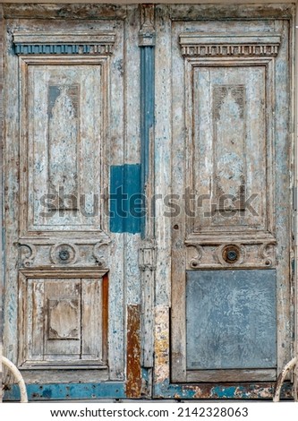 Old blue parisian door in the process of being painted
