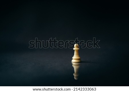 white pawn on a dark, black background, reflection, chess piece Royalty-Free Stock Photo #2142333063