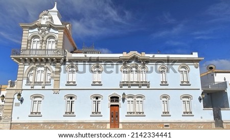 Revivalist style mansion built from 1912 to 1917 with two story-a turret in the NW corner with mansard and stork nest on top-west facade punctuated by windows with iron guards. Faro-Algarve-Portugal.