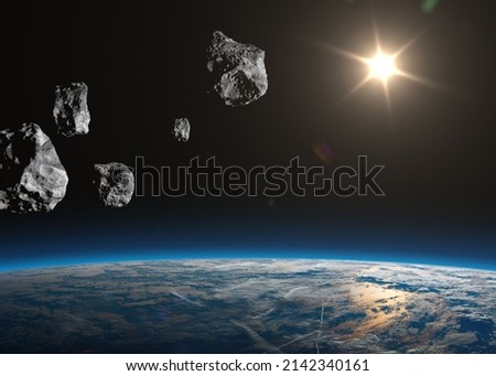 Big and small asteroids near planet Earth. Potentially hazardous asteroids (PHAs). Asteroids in outer space near Earth planet. Meteorit is solar system. Elements of this image furnished by NASA. Royalty-Free Stock Photo #2142340161