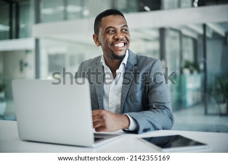 My end goal for this business is getting closer. Shot of a handsome young businessman sitting alone in his office and using his laptop. Royalty-Free Stock Photo #2142355169