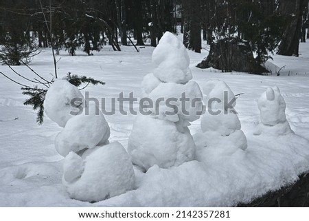 family of snowmen made of snow