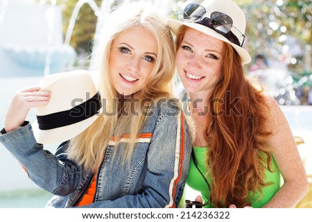 Two teenagers girl walking in city center