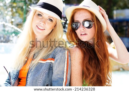 Two teenagers girl walking in city center