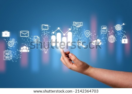 Hand pointing a growing virtual hologram stock with business icons. Stock market. Growth, progress, success, cloud, mail, contacts, global security. Internet of things.