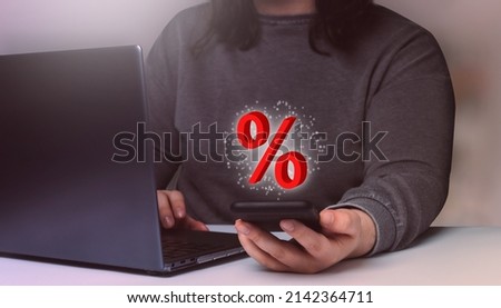 Woman checking discounts with laptop and smartphone. Internet of things. Business woman shopping online. Sales concept.