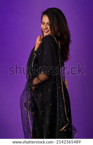 Portrait of a young girl or woman posing on purple background