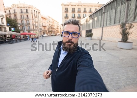Mid adult man taking selfie in center of Barcelona