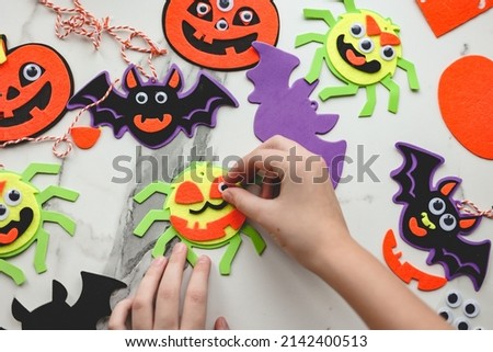 Children siblings sister and brother making decorations for Halloween party celebration. Do it yourself, diy, creativity, holiday concept.