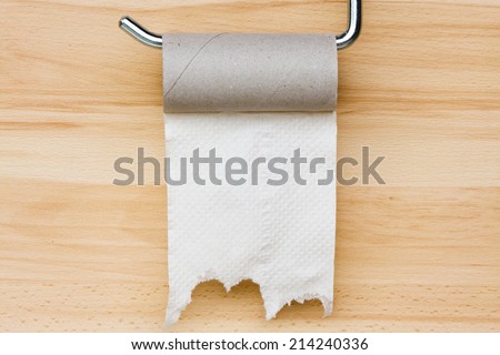 Toilet paper on wooden background. Empty space for text