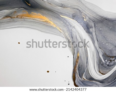 Abstract grey art with gold — black and white background with beautiful smudges and stains made with alcohol ink and golden paint. Grey fluid texture resembles marble, smoke, watercolor or aquarelle. Royalty-Free Stock Photo #2142404377