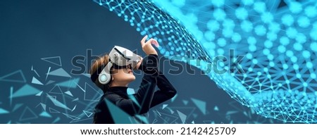Beautiful Asian woman in glasses of virtual reality. Augmented reality. Future digital technology game and entertainment. Metaverse technology concept. VR. Royalty-Free Stock Photo #2142425709