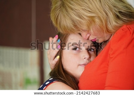 Mom and daughter cute hug and kiss. Family values ​​with the manifestation of emotions