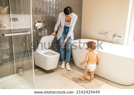 Caring female parent toilet-training her baby boy Royalty-Free Stock Photo #2142429649
