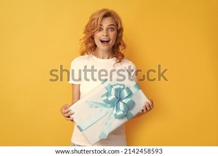 surprised redhead lady with giftbox. womens day