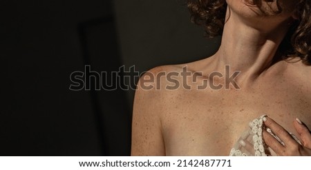 Woman with pigmentation and freckles on the body close-up on a dark background Royalty-Free Stock Photo #2142487771