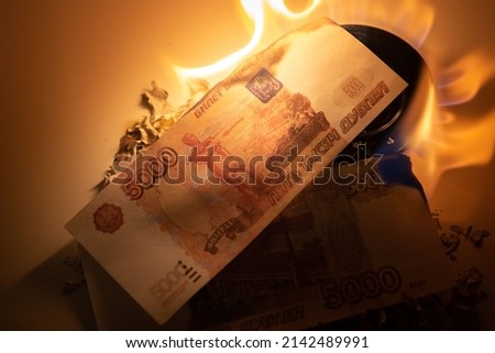 Burning rubles banknotes. High natural gas bills. Russian rubles. Russian money. Close-up photo. Finance concept. Money background and texture.