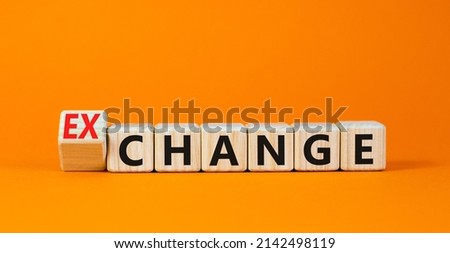 Change or exchange symbol. Turned wooden cubes and changed the concept word Change to Exchange. Beautiful orange table orange background. Copy space. Business and change or exchange concept. Royalty-Free Stock Photo #2142498119