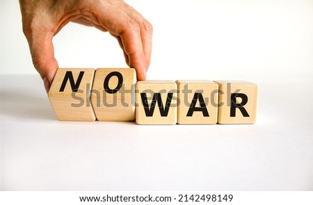 No war symbol. Businessman turns cubes and changes concept words War to No war. Beautiful white table white background. Business and no war concept. Copy space.