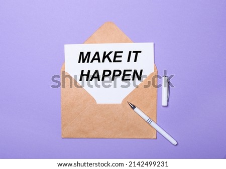 On a purple background, a white pen, a craft envelope and a white card with the text MAKE IT HAPPEN. View from above.