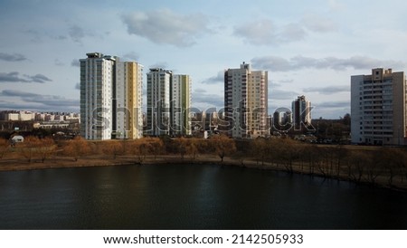 City block near the river. Multi-story houses. Water city system. Aerial photography.