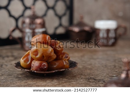 sukari dates is a kings date, serving in one little plate with arabian vives background. popular during ramadhan fasting month Royalty-Free Stock Photo #2142527777