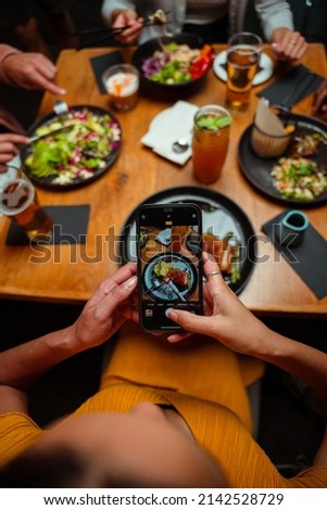 friends out for dinner taking pictures of food