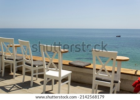Cafe  wooden summer terrace on beach with sea view