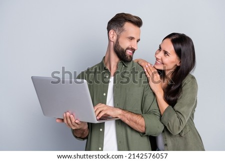 Photo of affectionate married guy lady use netbook browsing web discount typing isolated over grey color background
