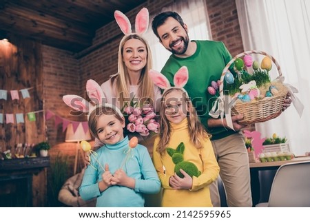 Photo of full positive friendly family hold easter eggs basket fresh tulips festive atmosphere indoors
