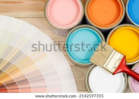 A painter is choosing a paint shade for the interior of the house's walls. with interior