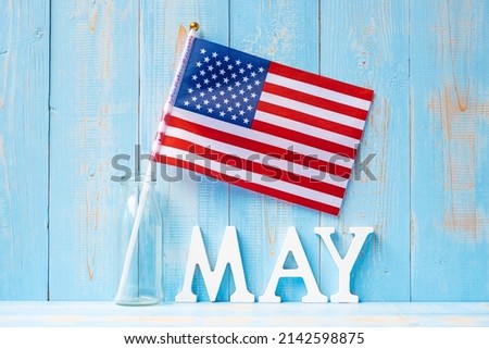 MAY text and United States of America flag on wooden table background. happy Memorial day and holiday celebration concepts