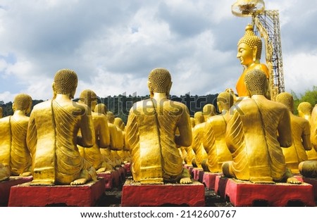 Rear view Lot of Golden Statue of Buddha sitting in meditation Belief Faith and Worship concept. Big buddha Press the hands together at chest In sign of respect religion culture