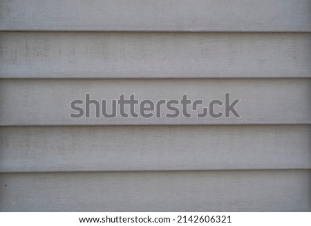 Texture of plastic gray siding on the wall.