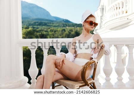 Portrait of young woman with towel and sunglasses in balcony on Lazy morning
