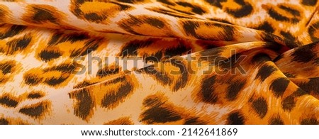Silk fabric with leopard print. With this silk chiffon, you will have a chic project in no time! each brown-black spot stands out against a yellow background. Flowing and wavy in drapery